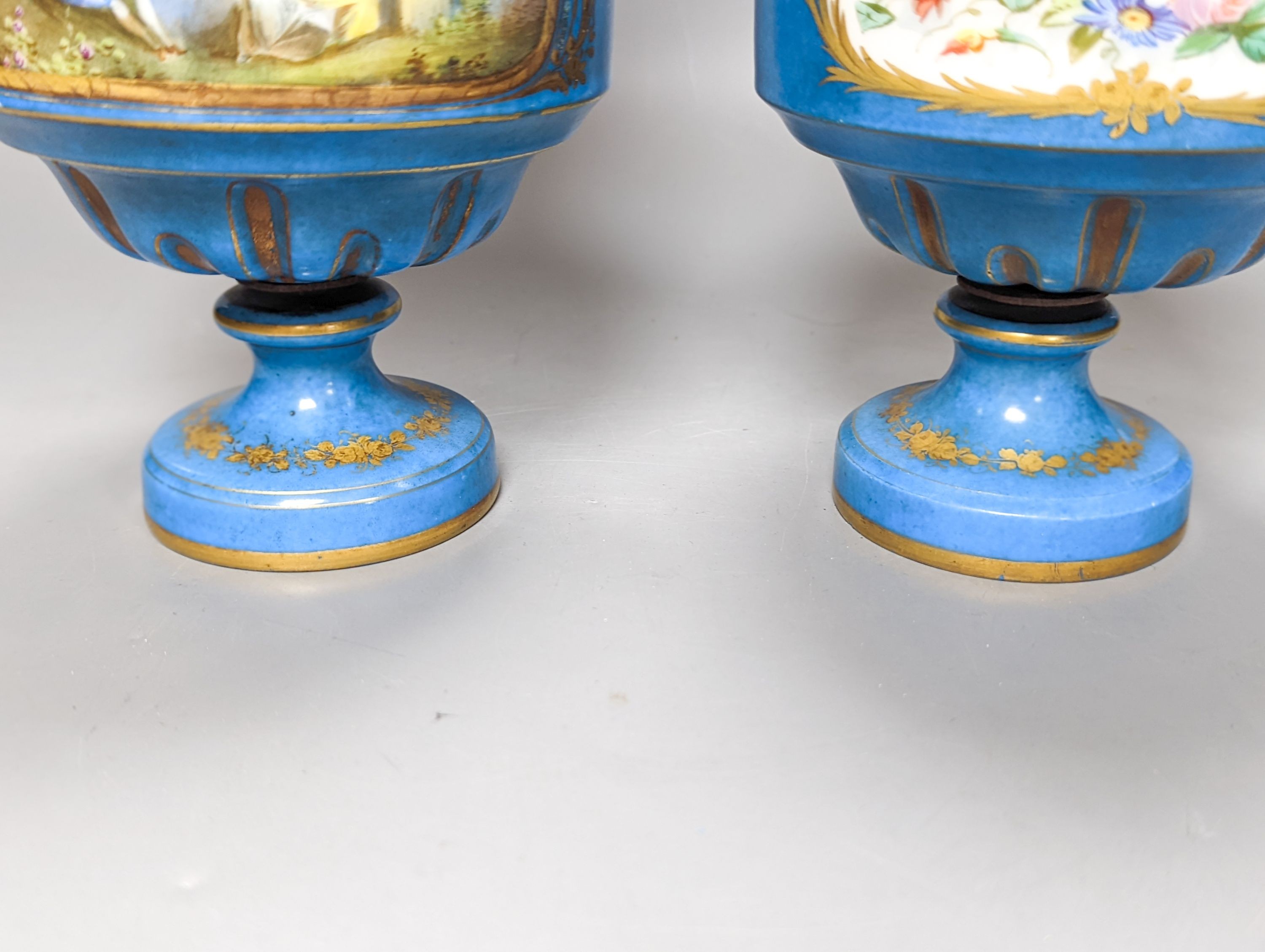 A pair of Sevres style porcelain bleu celeste ground vases and covers, 34cm